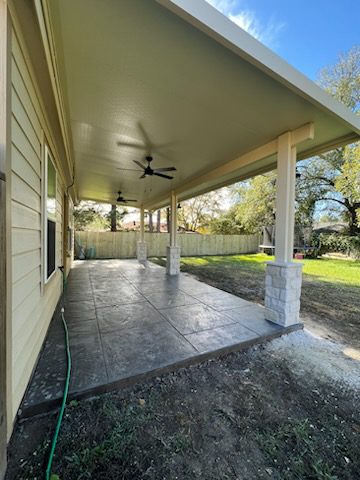 Aluminum patio cover with stamped concrete in a backyard in Fulshear, TX Aluminum patio cover with stamped concrete in a backyard in Fulshear, TX
