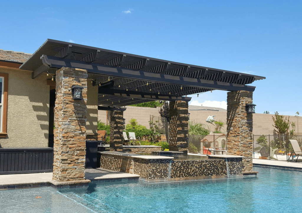 Cedar pergola outdoor patio shade structure with lighting and stone columns in a Houston backyard Cedar pergola outdoor patio shade structure with lighting and stone columns in a Houston backyard